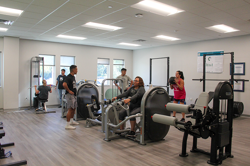 Two Exercise Science students supervise patients during free exercising