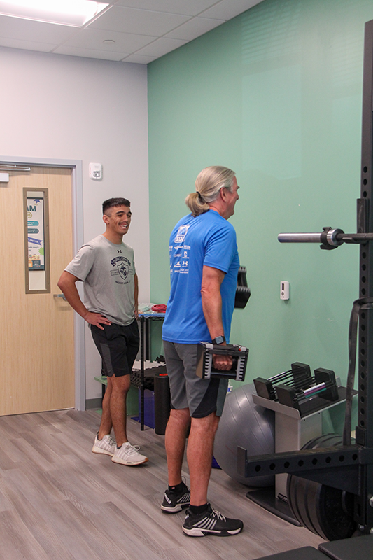 JU Exercise Science student supervises patient as they exercise